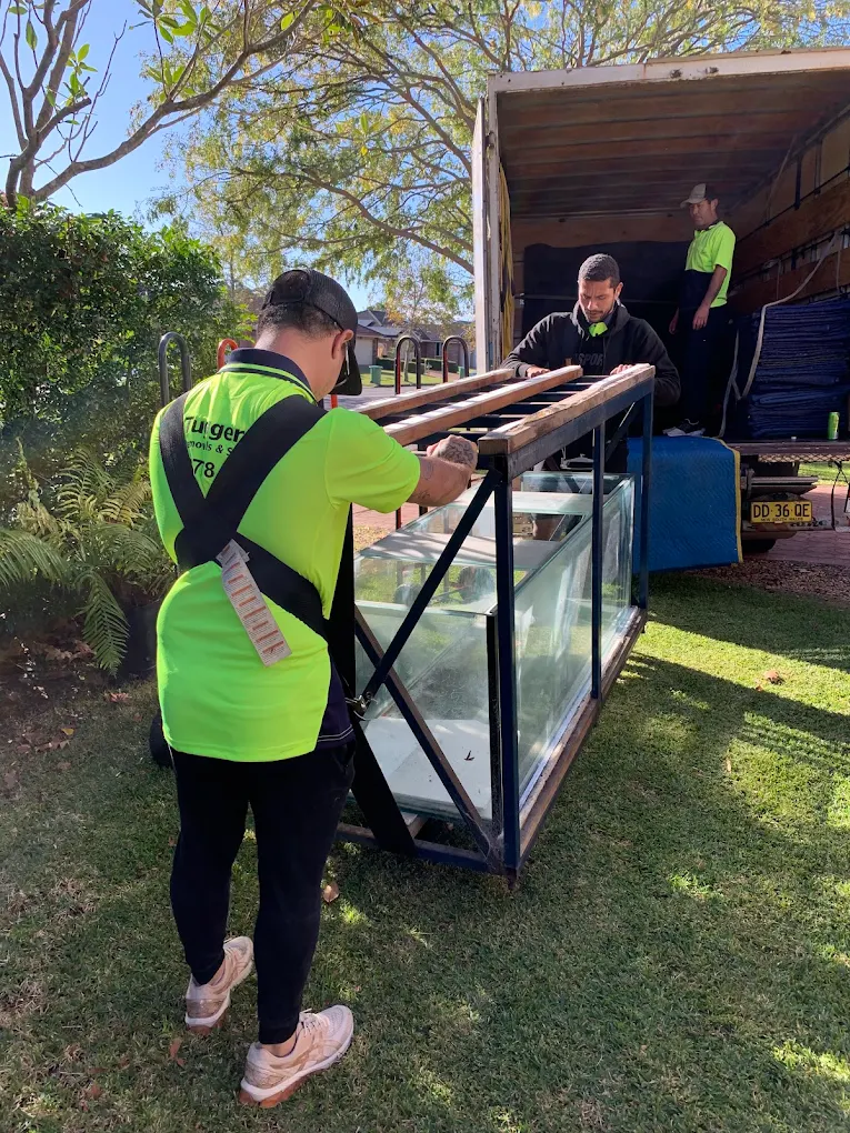 Boys Carrying Fish tank, plus steel frame with Shoulder Straps